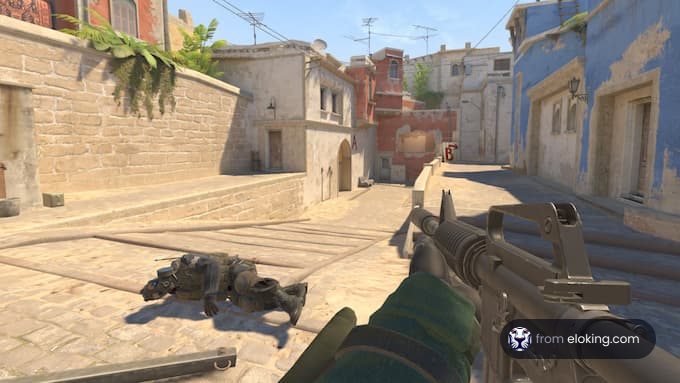 First-person view of a shooter game with a focus on a gun and a fallen enemy in an urban setting