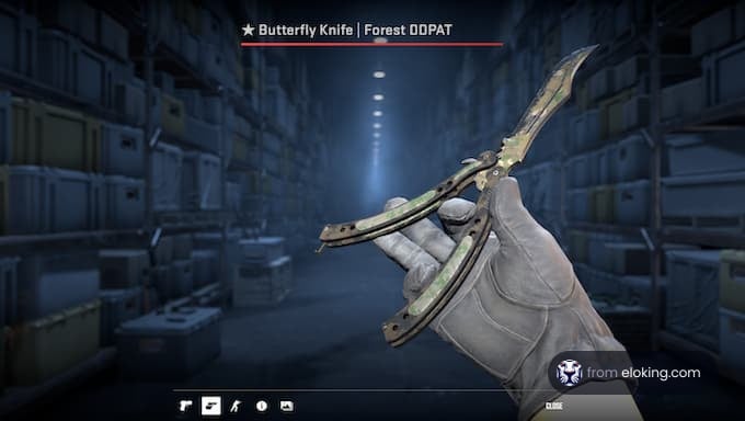 Hand wearing gloves holding a Butterfly Knife Forest DDPAT in an industrial warehouse