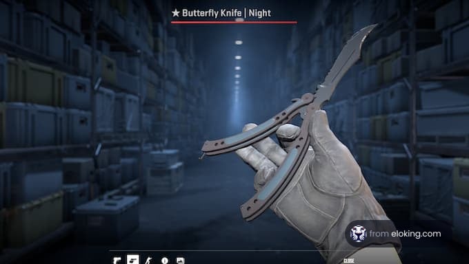 Person holding a butterfly knife in a dimly lit warehouse