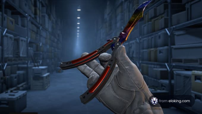 A colorful butterfly knife held in a hand inside a dark storage area.