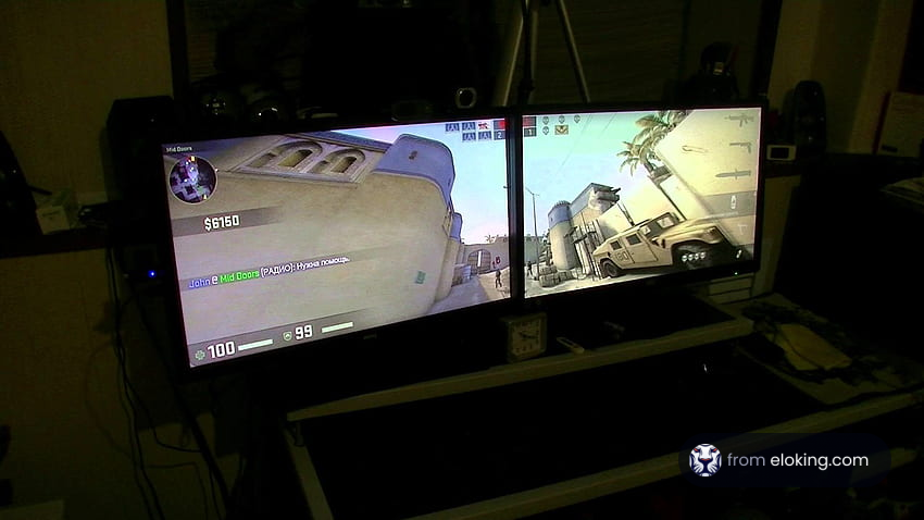 Dual monitors displaying a first-person shooter game
