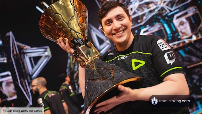 Esports player holding a large trophy with a joyful smile