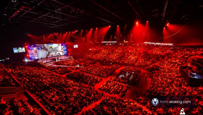 A packed audience at an esports event in a vibrant arena.