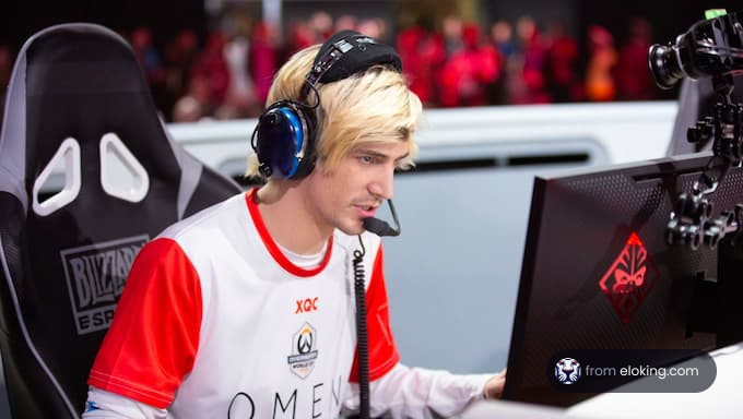 Esports player focusing during a game, wearing a white jersey and headset