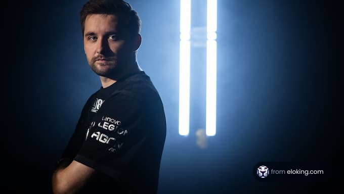 An esports player posing in dramatic backlighting