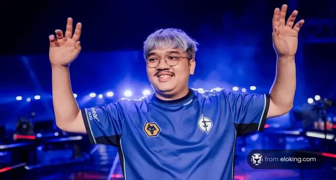 Esports player smiling and waving in gaming arena