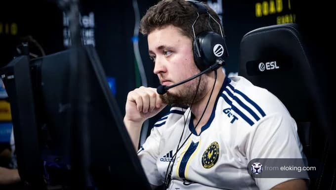 A focused esports player wearing a headset during a tournament.