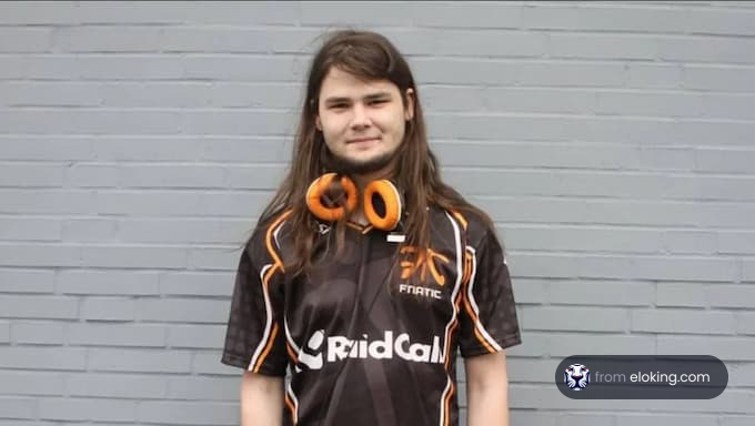 Esports player wearing a Fnatic jersey and orange headset