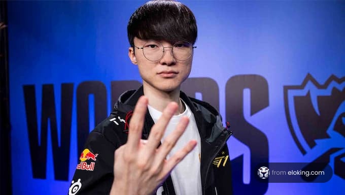 Esports player making a hand gesture in front of competition backdrop