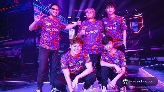 A group of five esports players celebrating at a gaming event.