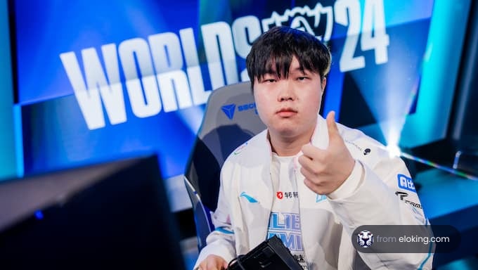 A gamer giving a thumbs up at the esports Worlds 2024 event.