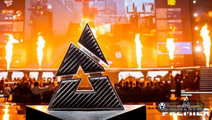 The trophy displayed at an esports event with a dynamic background.