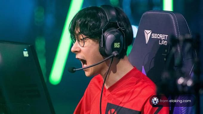 Excited young gamer shouting during a game, wearing a red jersey and gaming headset