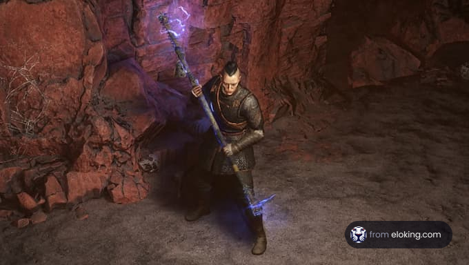 A fantasy warrior mage holding a glowing staff in a rocky cave.