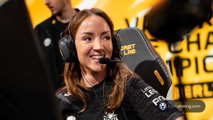 A female gamer smiling at an esports event.
