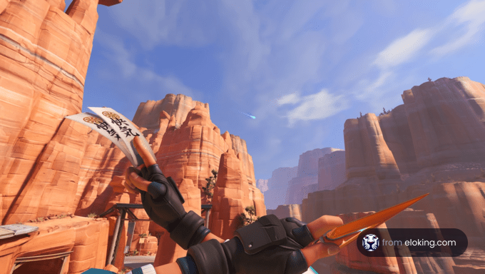 First-person view of a player holding a knife in a desert canyon in a video game