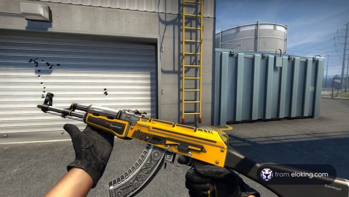 First-person view of a player holding a yellow and black gun in a video game with industrial background