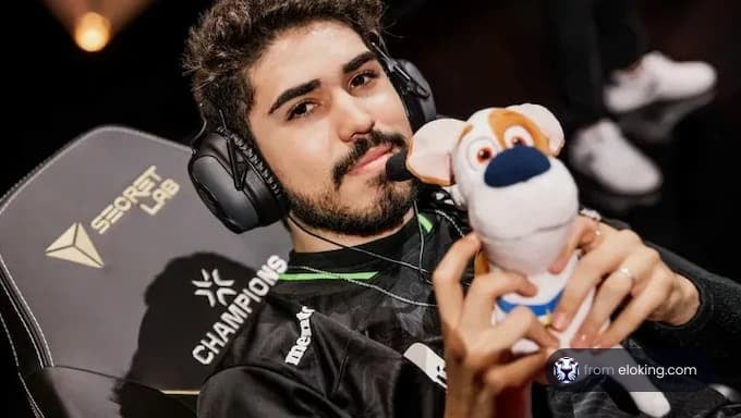 Gamer holding a stuffed animal at a champions event