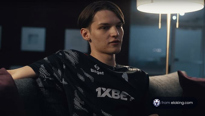 A gamer in a 1xbet jersey relaxing on a couch.
