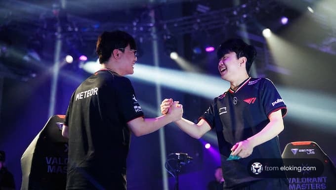 Two cheerful players shaking hands at a gaming event.