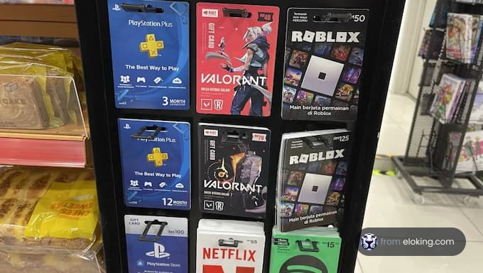 Assortment of gaming gift cards including PlayStation, Roblox, Valorant, and Netflix displayed at a store