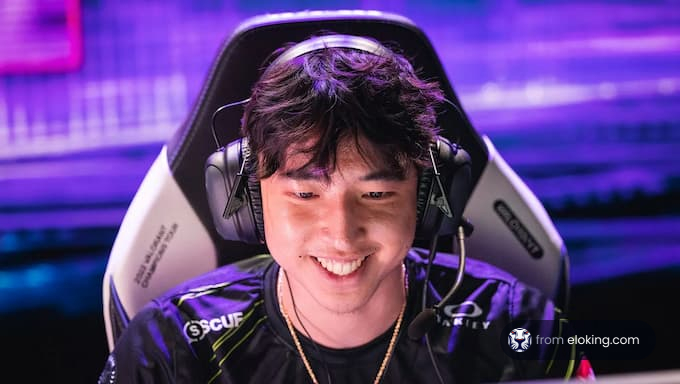 Happy esports gamer wearing a headset and smiling during game