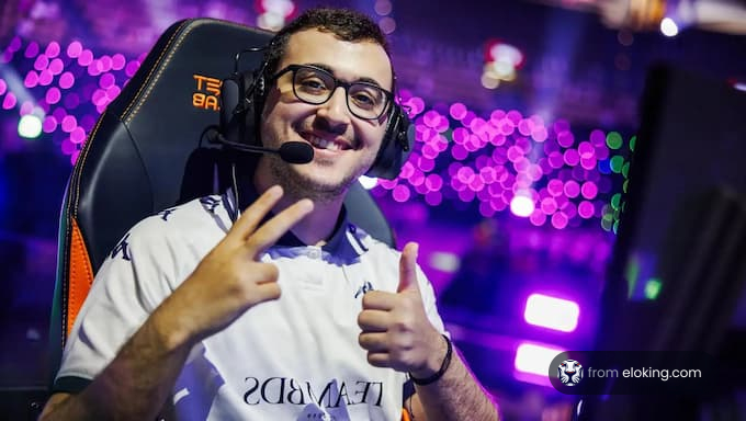 A happy gamer smiling while wearing a headset and making a peace sign.