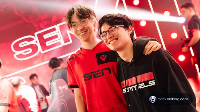 Two happy gamers wearing SEN branded clothing at an esports event