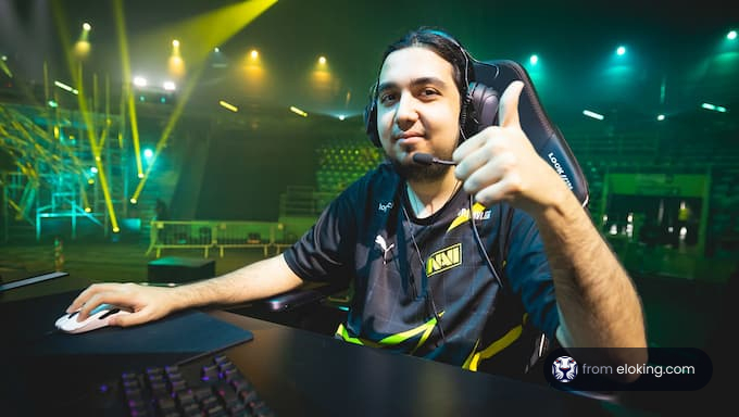 Professional esports player giving a thumbs up at a gaming event