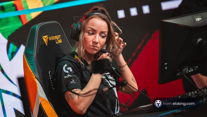 A focused female gamer preparing for an esports match.