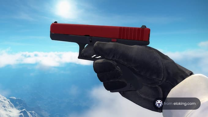 Hand holding a red pistol against a blue sky with clouds