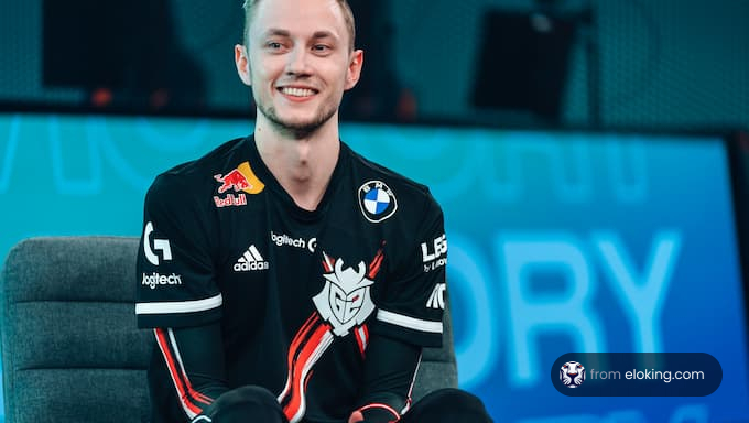 Smiling man in esports jersey sitting in an interview