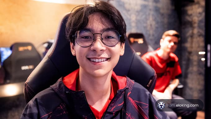 Young man with glasses smiling cheerfully at a gaming event