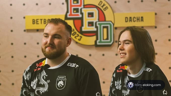Two happy individuals wearing team jerseys at a darts club