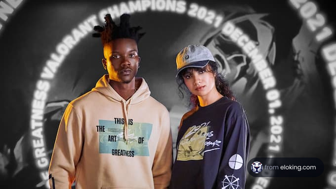 Two models posing in Valorant Champions 2021 themed clothing against a stylized backdrop