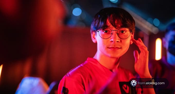 Young man with glasses smiling during a night event